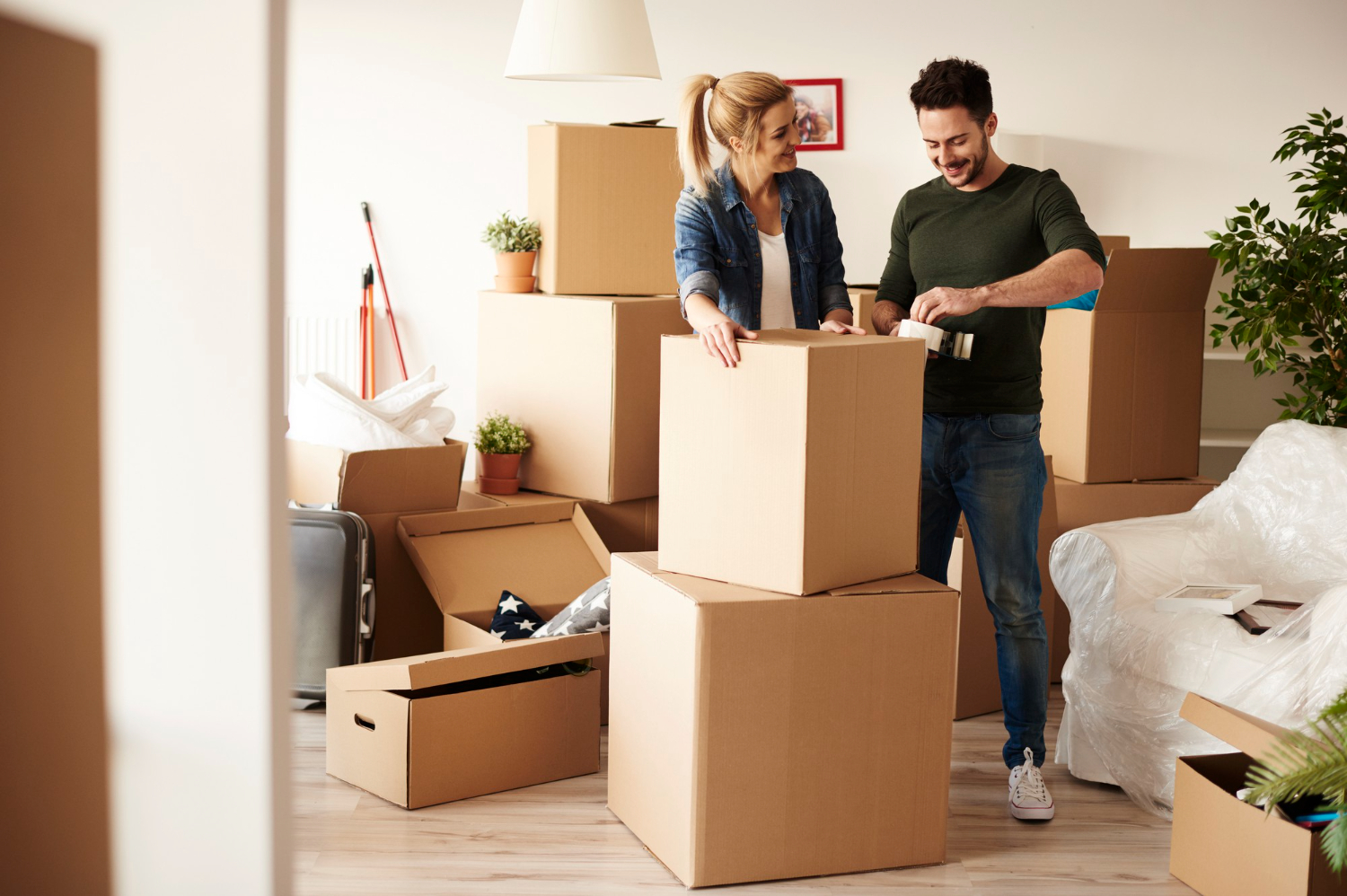 couple-packing-stuff-among-plenty-cardboard-boxes.jpg